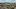 Panoramaaufnahme von St. Gallen mit Blick über die Stadt, Wohnviertel, Kirchen und bis zum Bodensee im Hintergrund.
