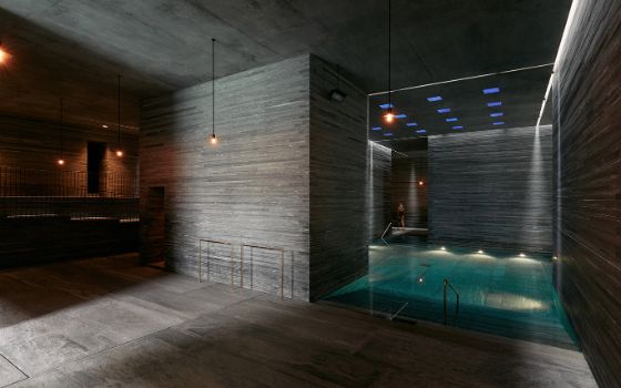 Moderner Spa-Bereich im minimalistischen Stil mit Wänden aus Quarzit und einem beleuchteten Pool.
